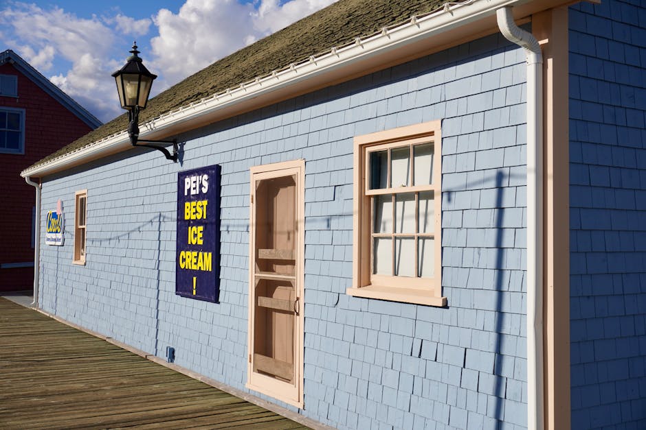 Charming ice cream shop on a sunny boardwalk, featuring coastal architecture.