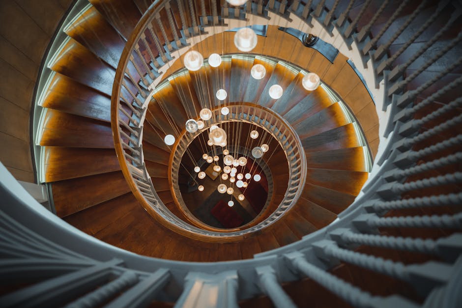 A stunning spiral staircase in London with artistic lighting, viewed from above.