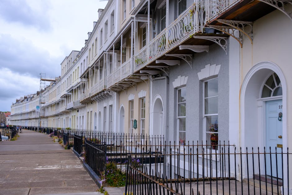 Charming Georgian terraced houses in England with ornate balconies and arches.