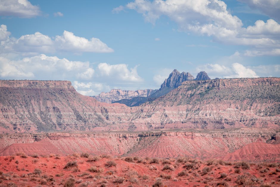Stunning view of red rock formations with a bright sky, capturing nature's beauty.