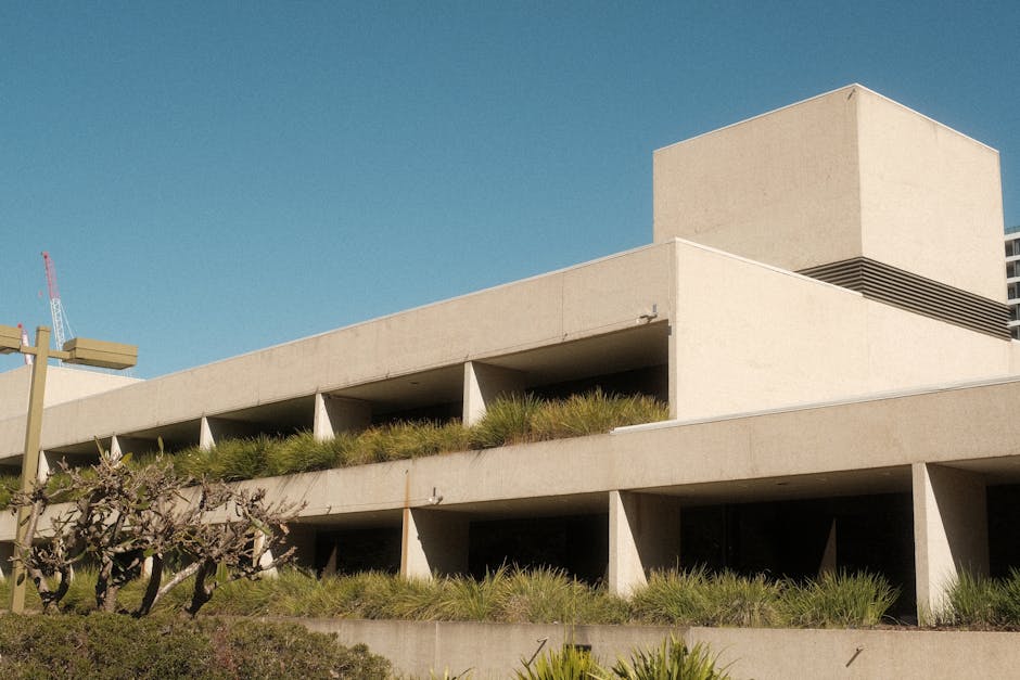 Explore the striking brutalist architecture of the Queensland Art Gallery in Brisbane under a clear sky.