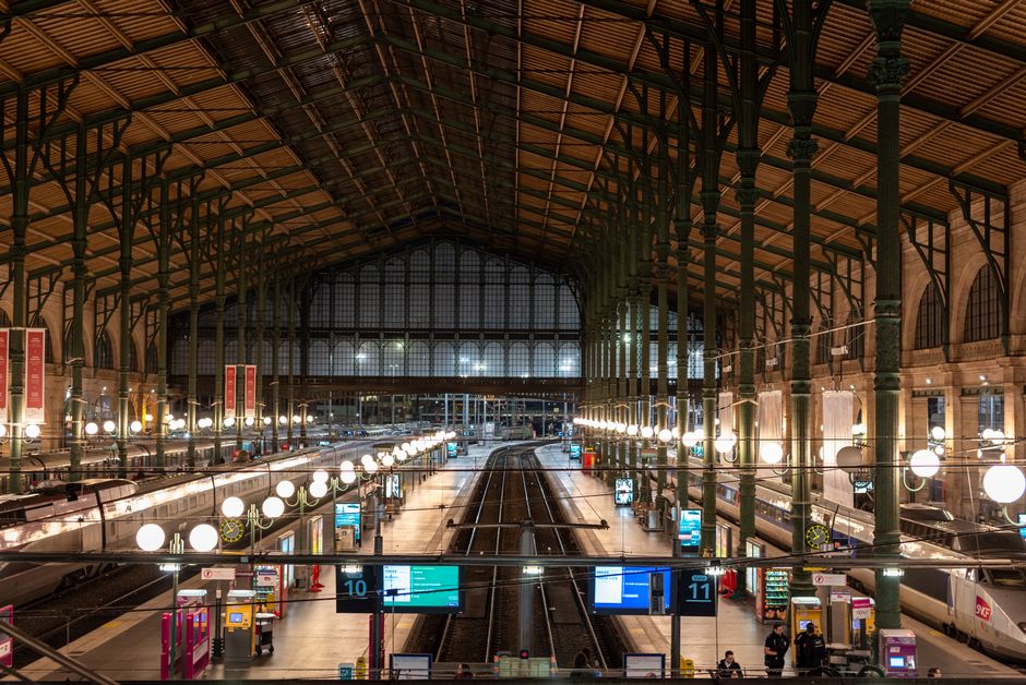Interior view of Gare du Nord train station in Paris, showcasing its architecture and tracks.