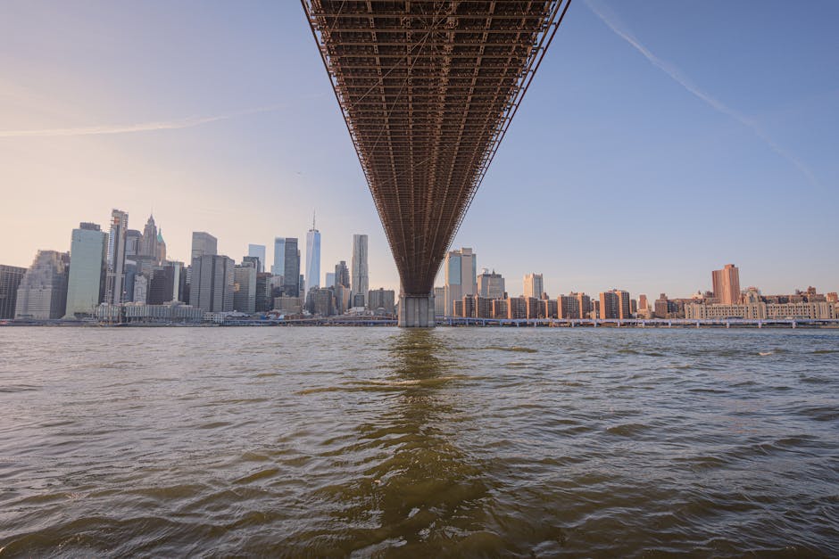 Captivating view of the Brooklyn Bridge with Manhattan skyline during sunset.